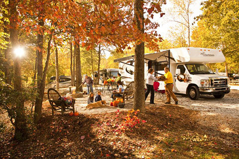 Famili Having Fun In The Good Besides Their RV