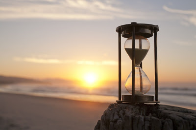 Sand Watch In A Sunset